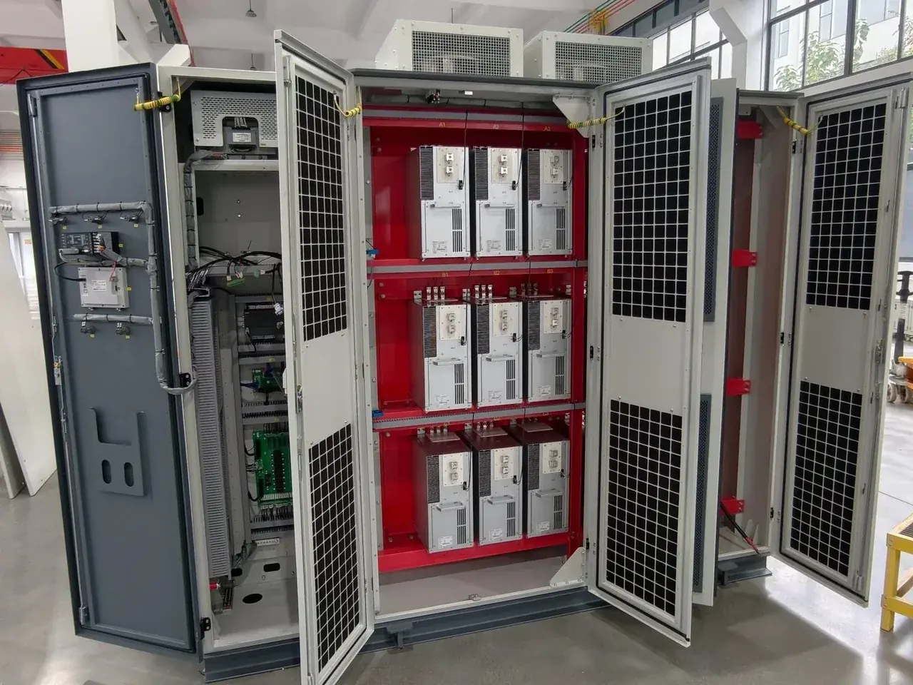 Drive cabinet with its doors open, showing power modules on the internal rack